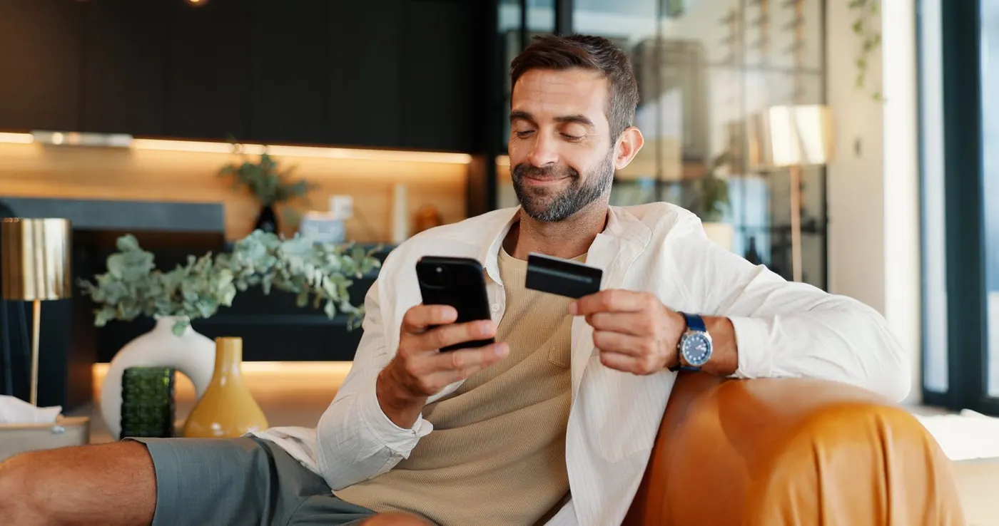 Business owner reviewing his payments on his phone